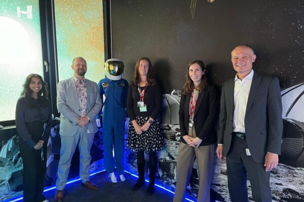 Digital Infrastructure and England's Connected Heartland team with European Space Agency (ESA) team members in the Moon and Mars Room, next to a space suit